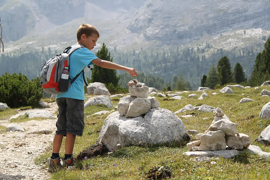 A boy on a hiking break in the Dolomites