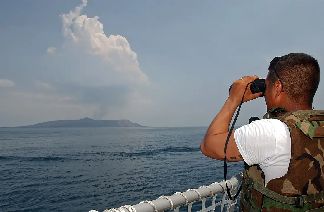 Man observes the eruption of Jabal al-Tair Island
